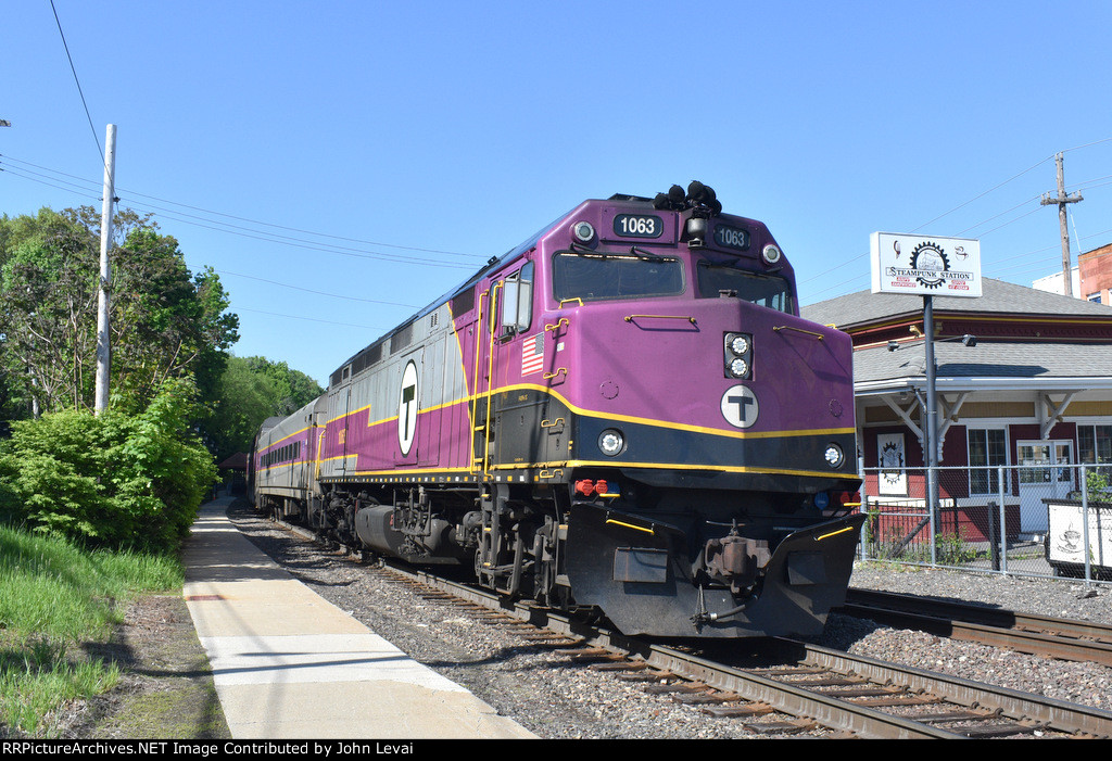 MBTA Train # 203 with F40PH-3C # 1063 departing Bradford Station passing the Steampunk Station restaurant on the right. I came up on this one from Boston and it was pretty busy in the open cars.